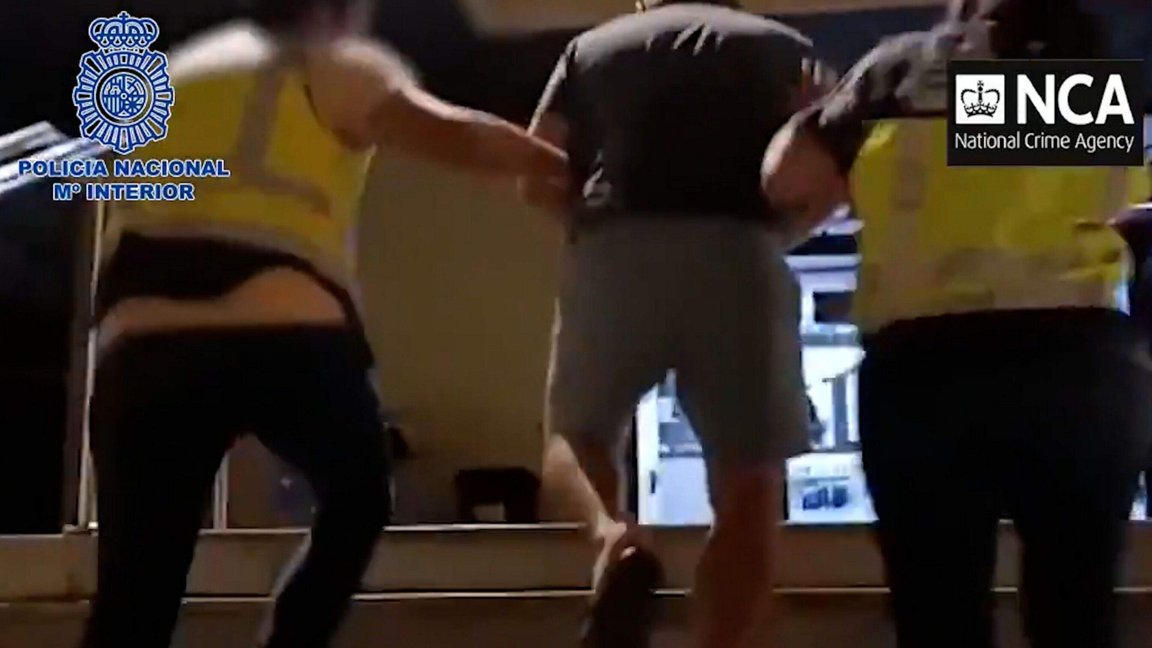 https://prod-img.crimeworld.com/public/incoming/fs1xt1-liam-byrne-being-escorted-by-spanish-and-uk-police/alternates/BASE_SIXTEEN_NINE/Liam%20Byrne%20being%20escorted%20by%20Spanish%20and%20UK%20police