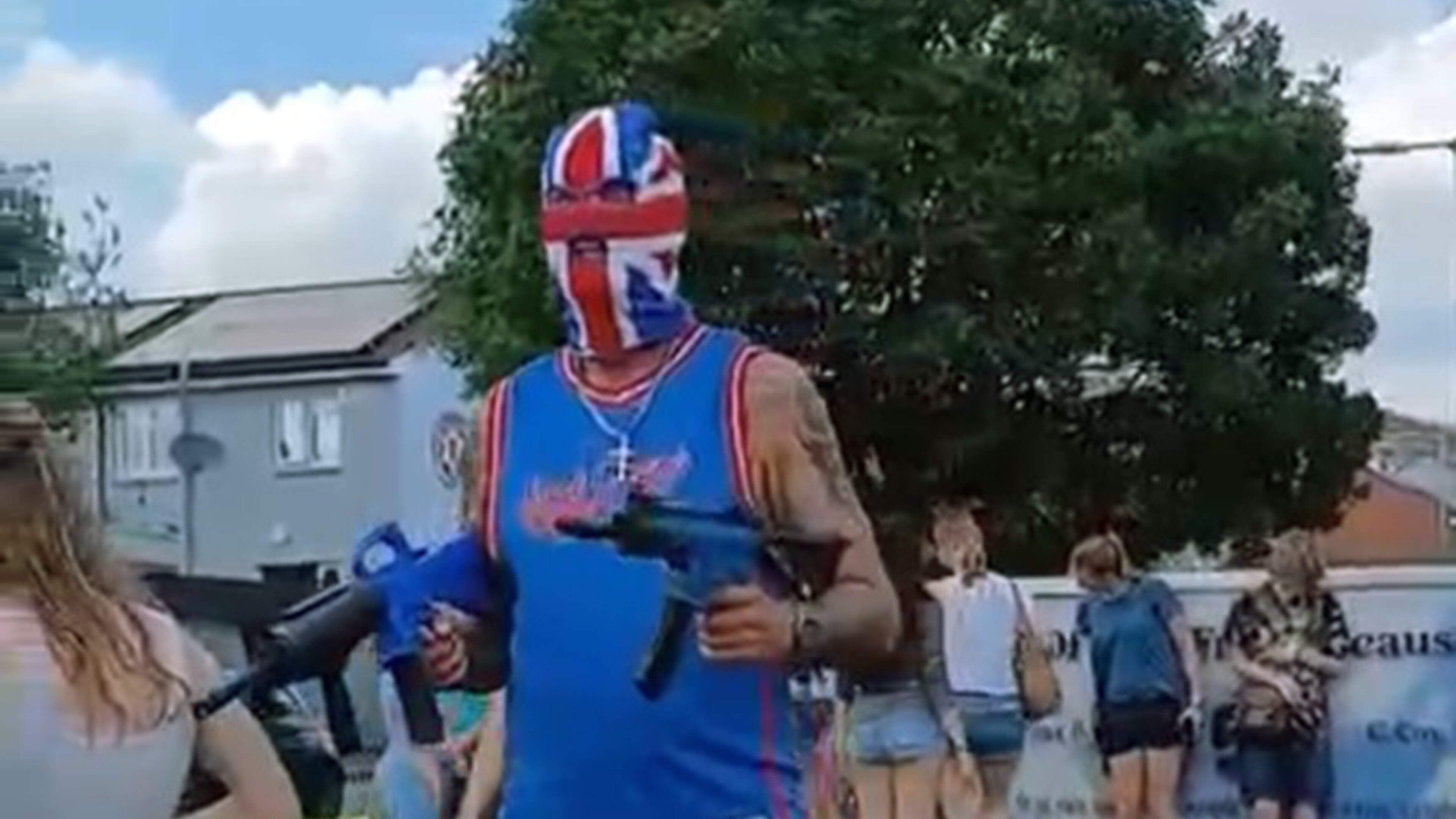 Cops under fire after balaclava-clad man poses with imitation guns